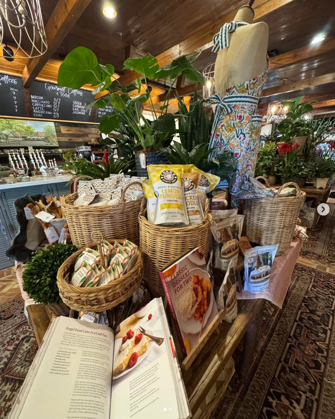 Corks Popcorn bags displayed in baskets on a retail shop shelf