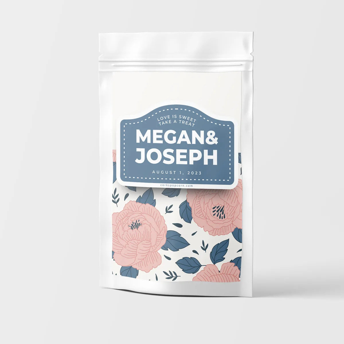 Custom wedding popcorn bag with a navy "Megan & Joseph" label and pink floral pattern
