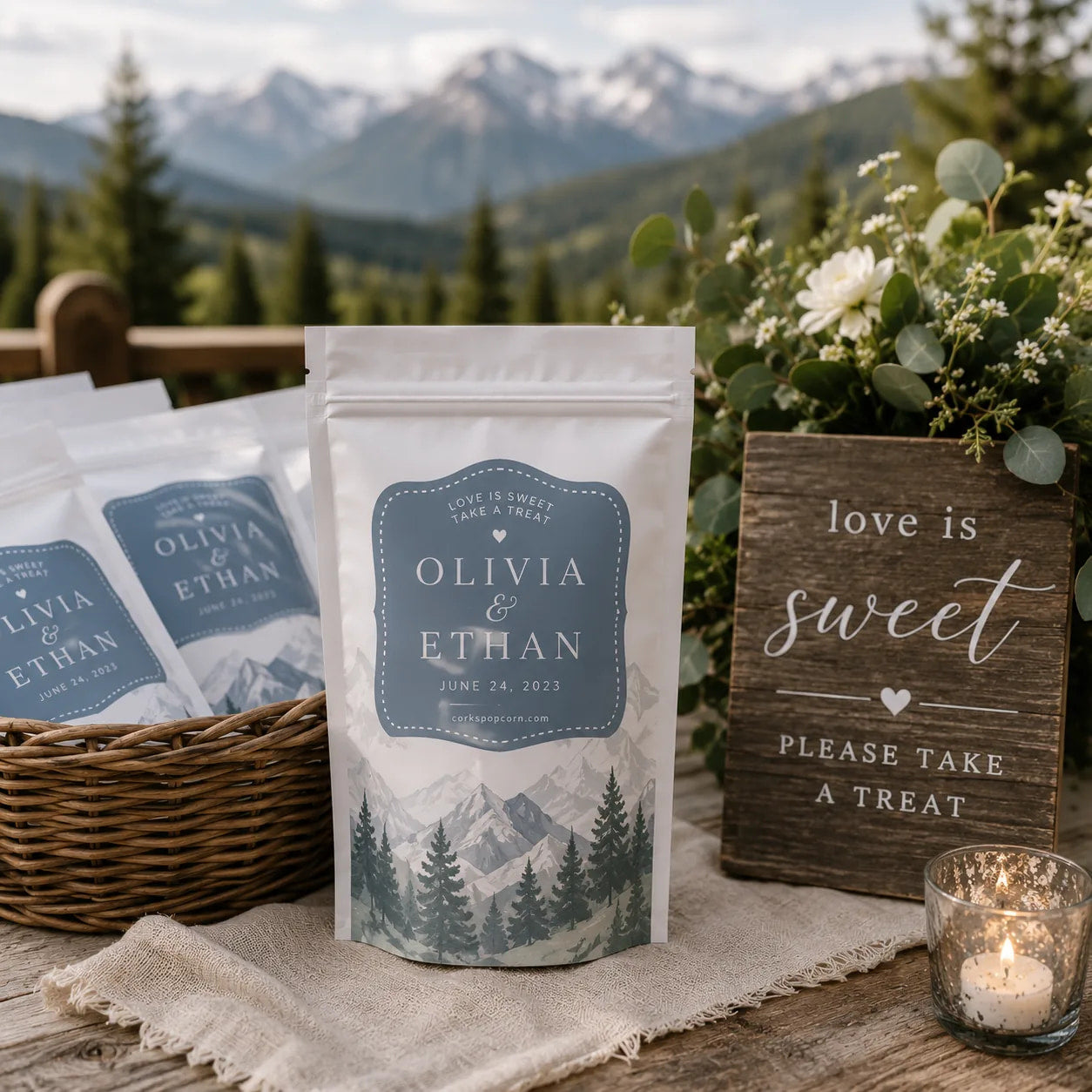 Custom Olivia & Ethan wedding popcorn favors in a basket at a mountain wedding